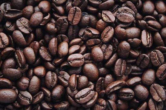 A close-up pile of dark roasted coffee beans