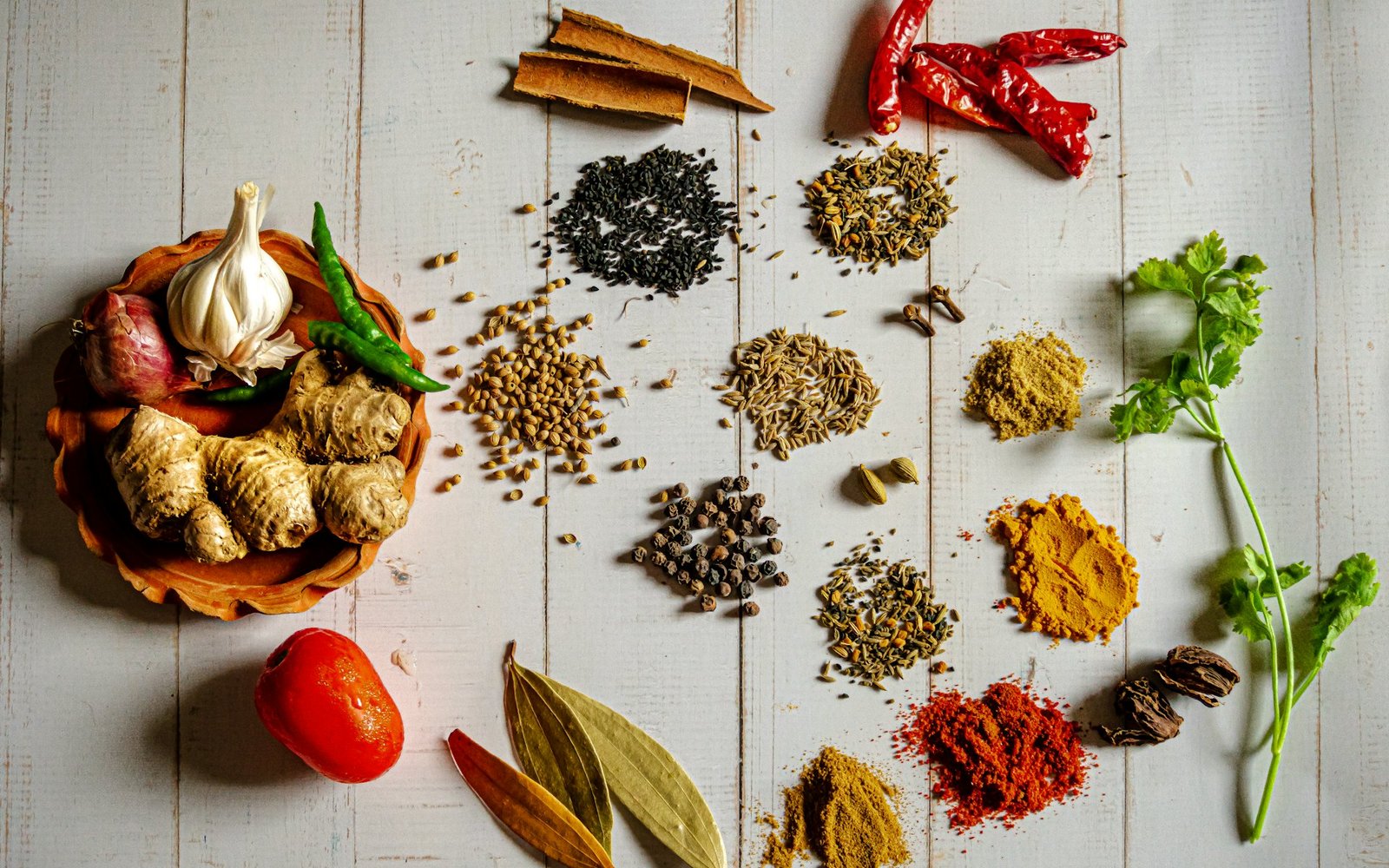 Raw spices and aromatics laid out at origin