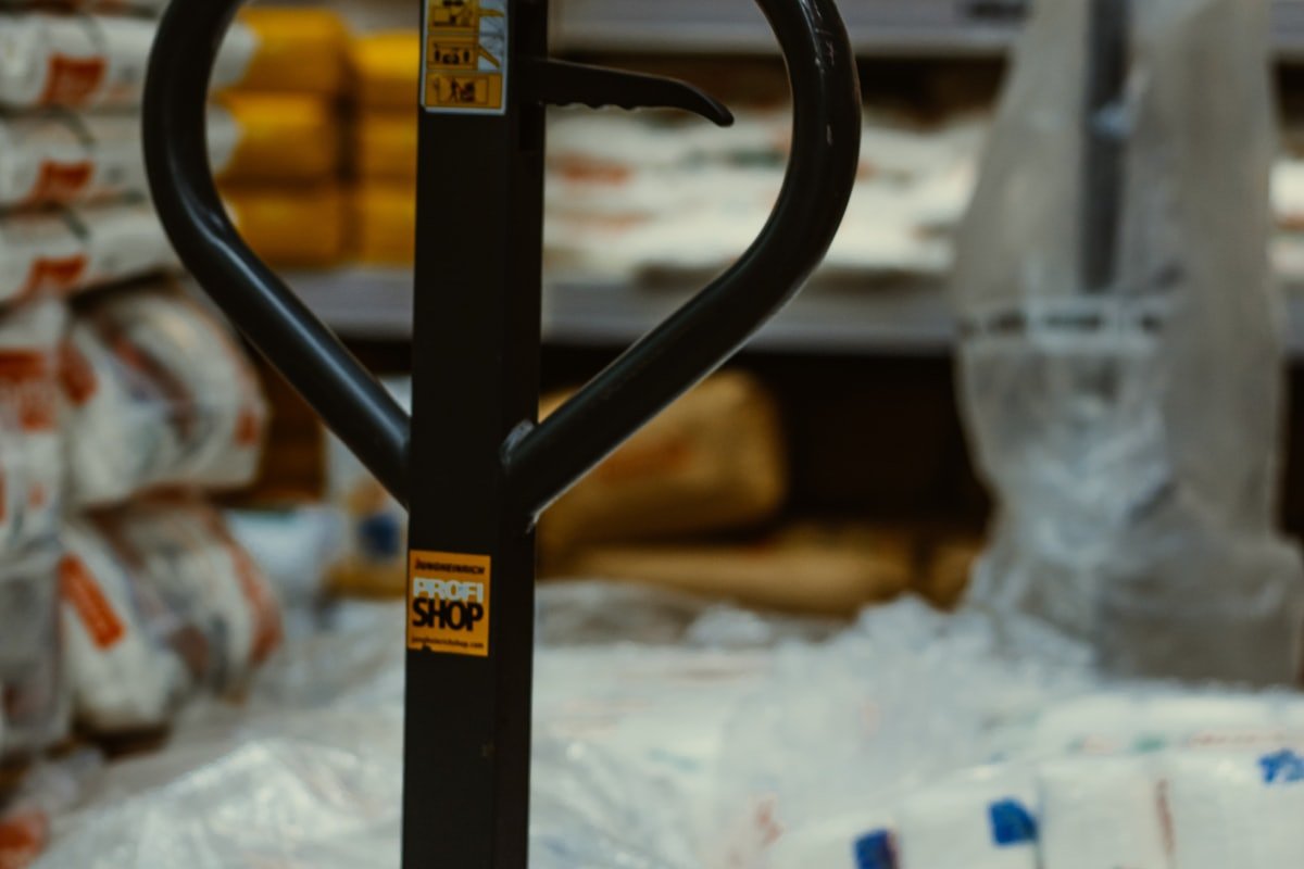 A pallet truck among stacked sacks