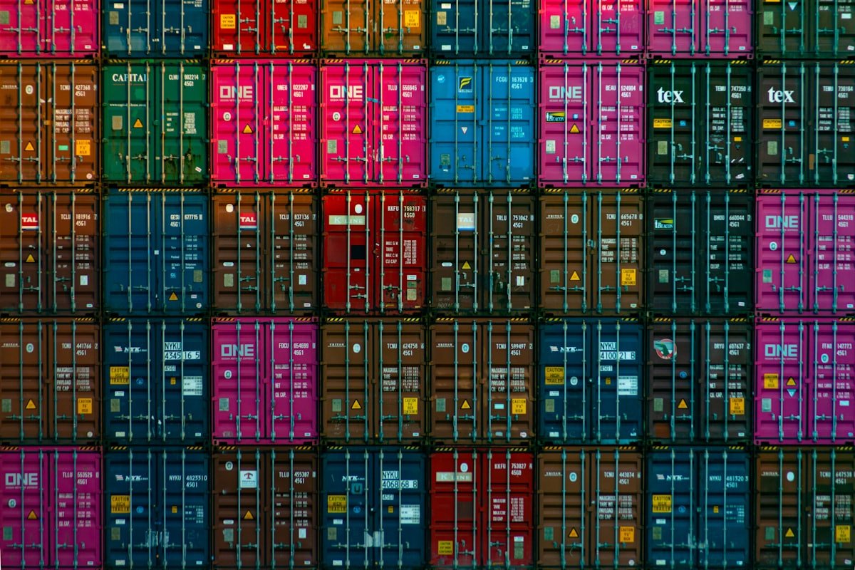 A wall of stacked shipping containers