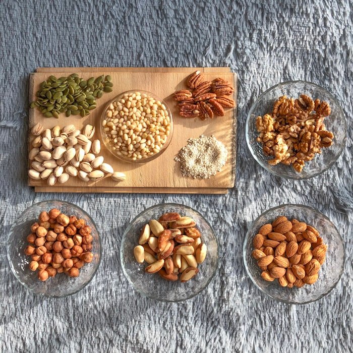 Pistachios, pecans, pine nuts and pumpkin seeds on a board