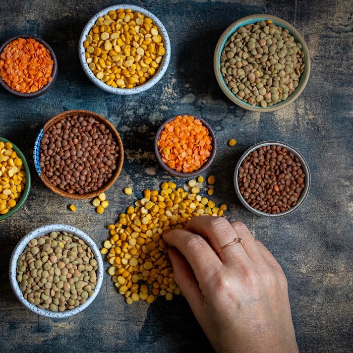 Bowls of split and whole lentils in six colours