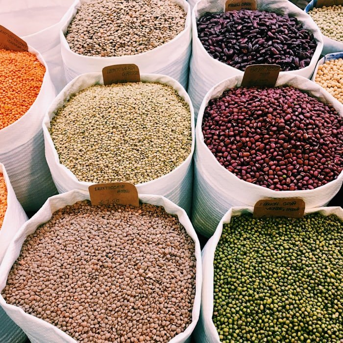 Open sacks of lentils and beans at a wholesale market