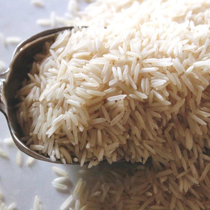 Raw white basmati rice on a metal scoop