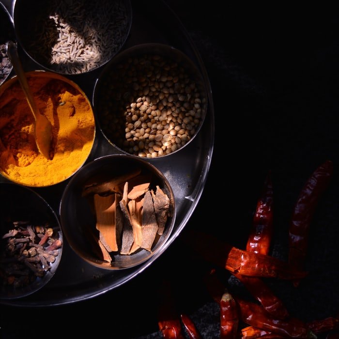 Turmeric, coriander and whole spices on a tray